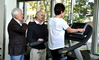 Emeritus Professor Perry Bartlett and Dr Daniel Blackmore have shown exercise boosts cognition healthy older adults and the improvement was retained for up to 5 years. Two people stand next to a person walking on a treadmill